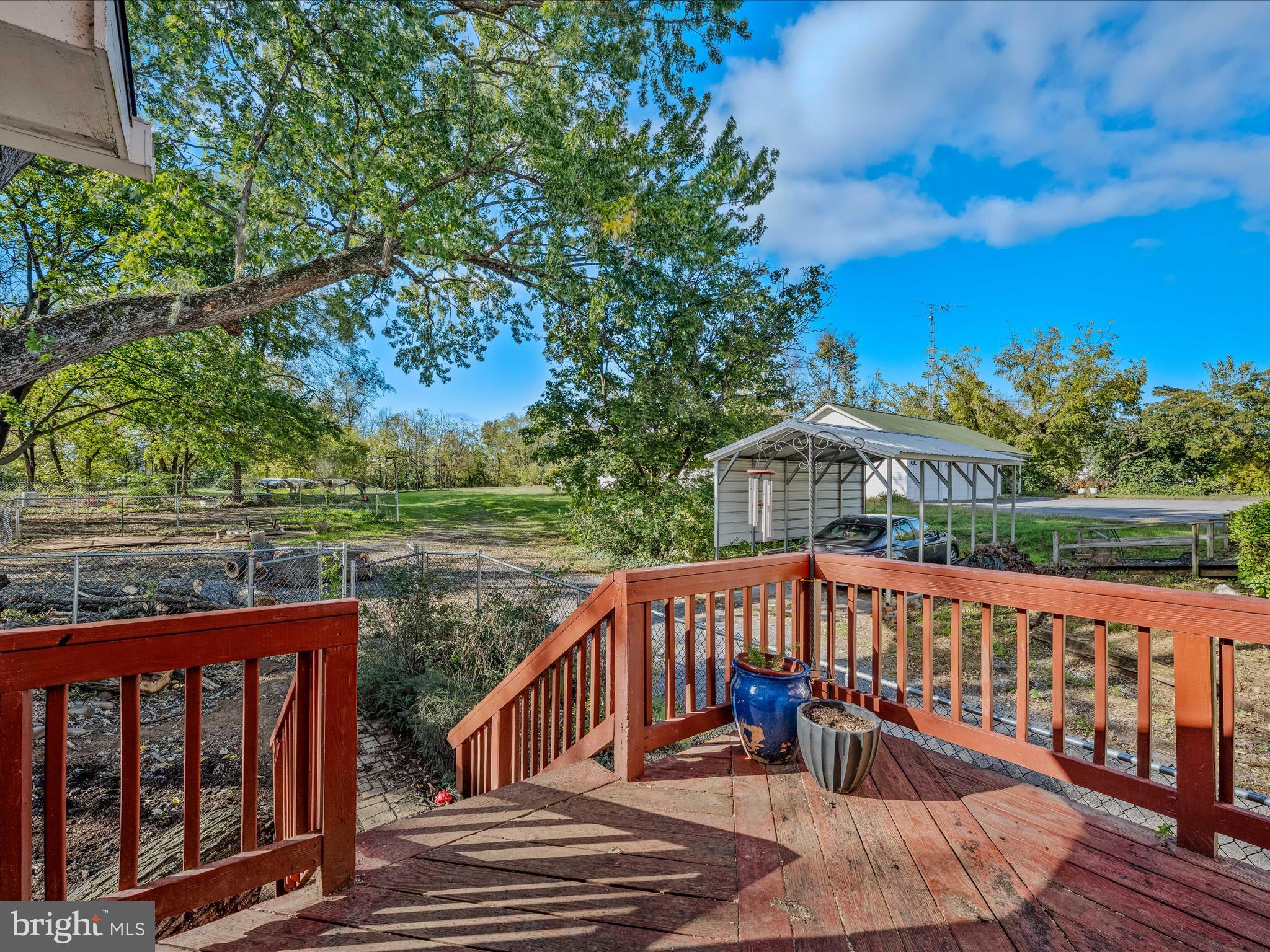 9872 Winchester Avenue Bunker Hill, WV 25413 - Photo 31 of 46 a view of a wooden deck with a yard