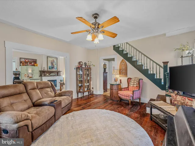 a living room with furniture a chandelier and a flat screen tv