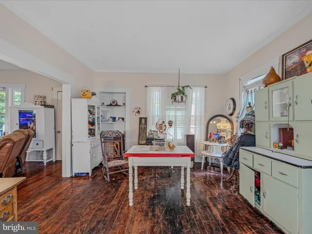 a dining room with furniture and wooden floor