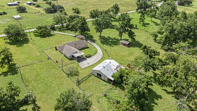 an aerial view of a house with a yard basket ball court and outdoor seating