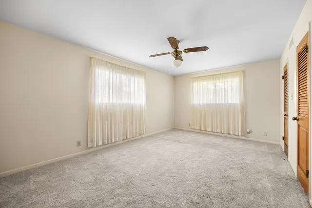 a spacious bathroom with a granite countertop sink mirror and double