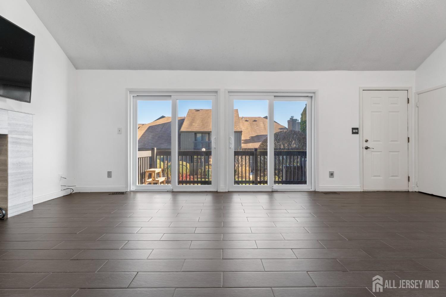 171 Westgate Drive Edison, NJ 08820 - Photo 12 of 49 a view of an empty room with a fireplace and a window