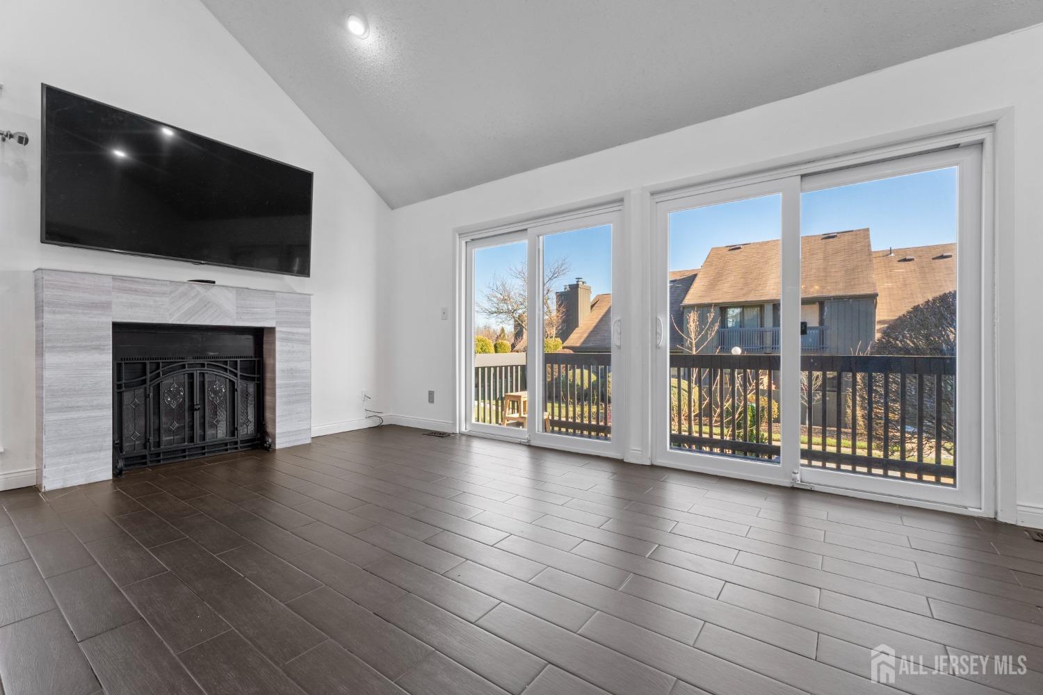 171 Westgate Drive Edison, NJ 08820 - Photo 13 of 49 a view of a livingroom with wooden floor and a fireplace