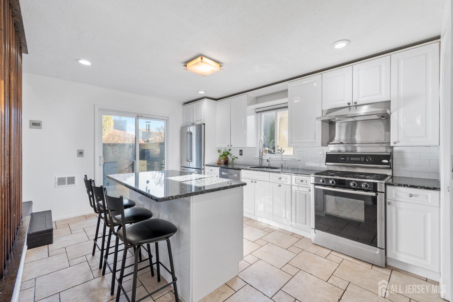 171 Westgate Drive Edison, NJ 08820 - Photo 17 of 49 a kitchen with granite countertop counter space a sink appliances and cabinets