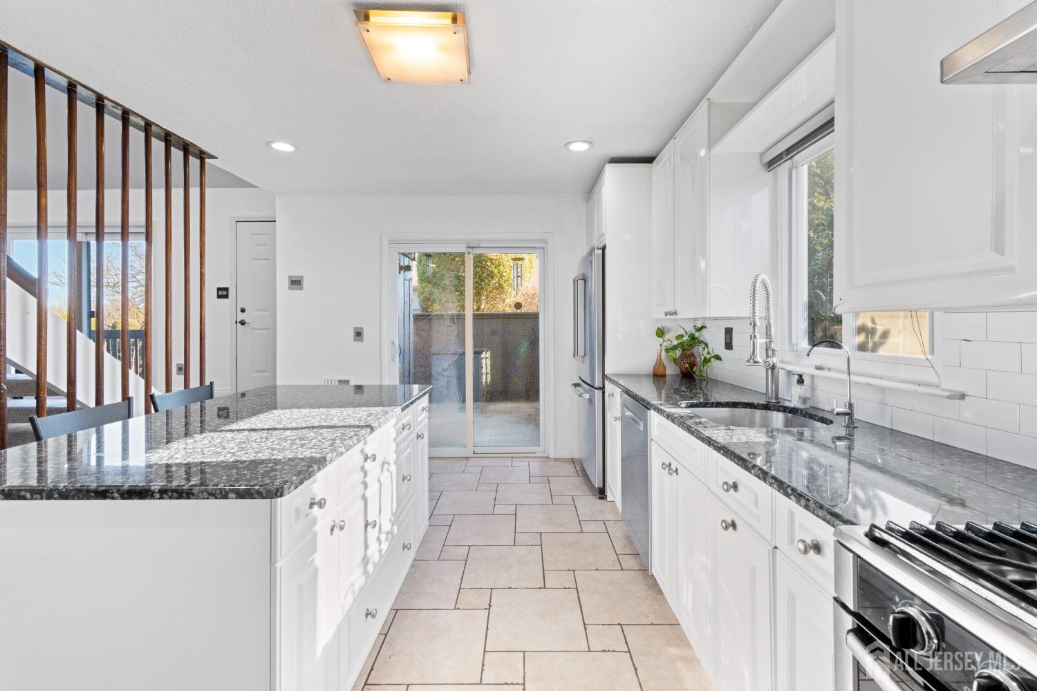 171 Westgate Drive Edison, NJ 08820 - Photo 18 of 49 a large kitchen with granite countertop a sink and a stove