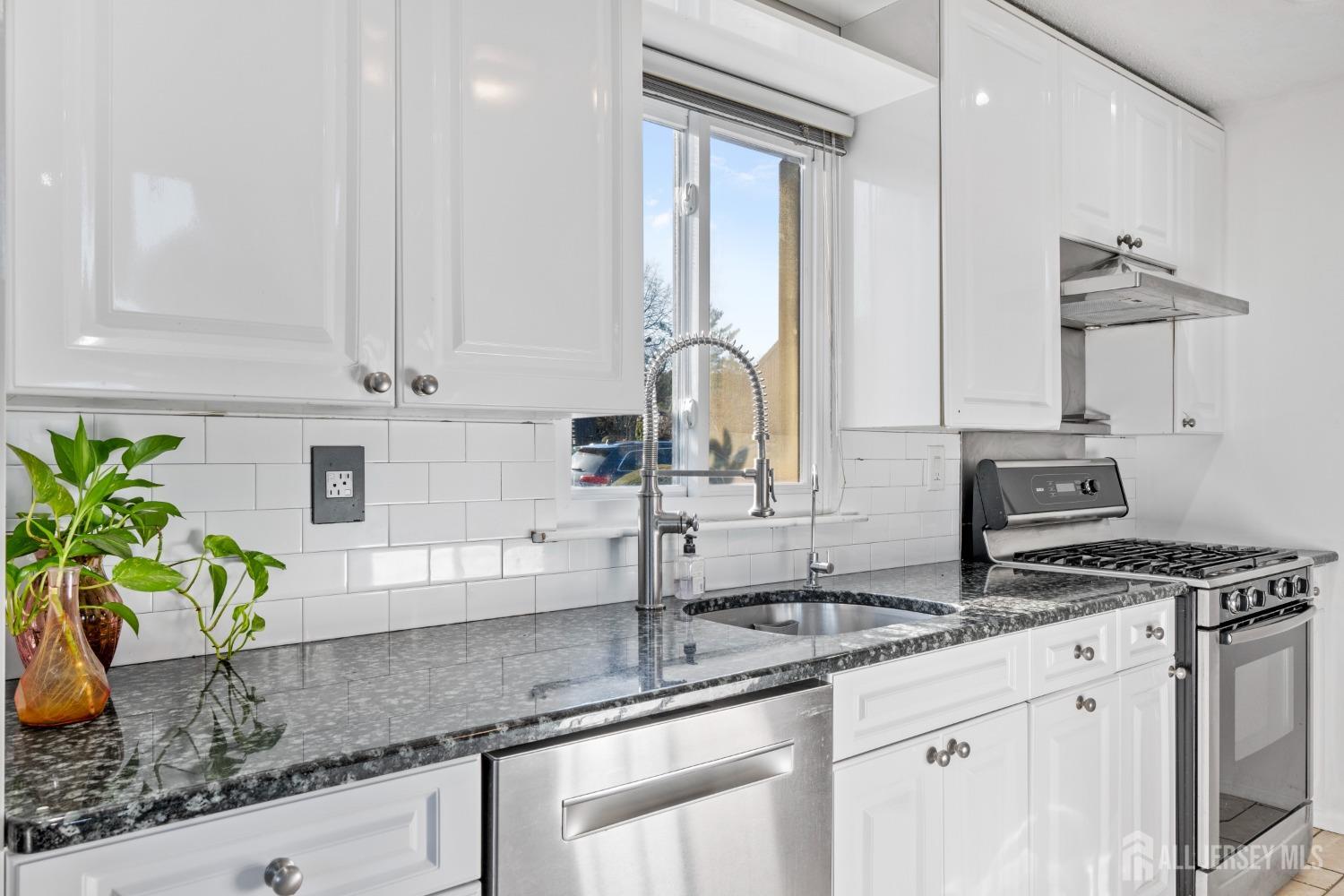 171 Westgate Drive Edison, NJ 08820 - Photo 23 of 49 a kitchen with stainless steel appliances granite countertop a sink stove and cabinets