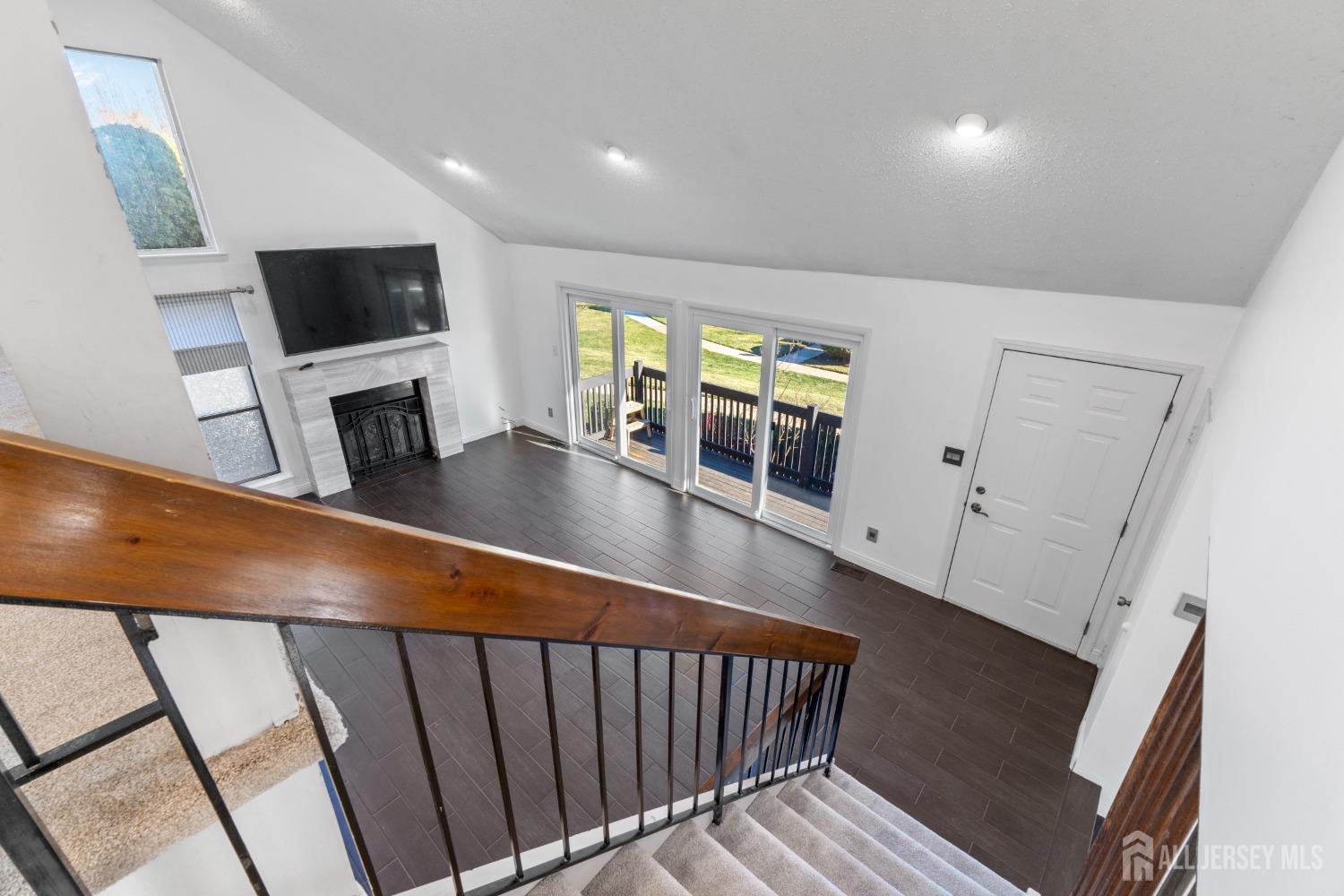 171 Westgate Drive Edison, NJ 08820 - Photo 40 of 49 a living room with furniture a flat screen tv and a fireplace