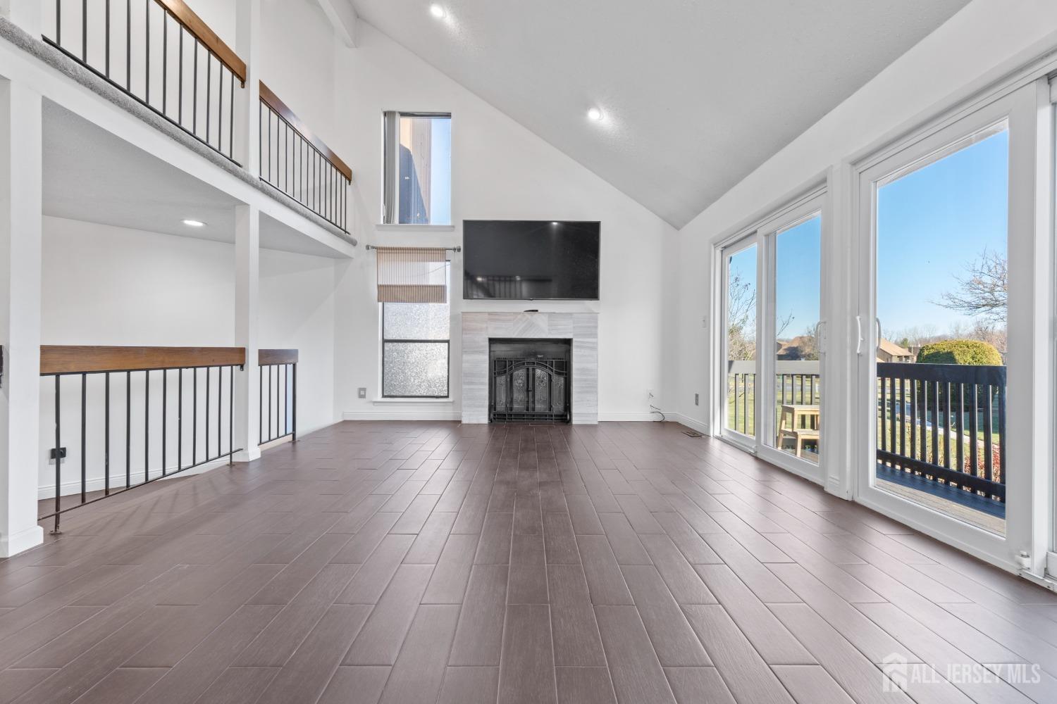 171 Westgate Drive Edison, NJ 08820 - Photo 8 of 49 a view of a livingroom with furniture a flat screen tv wooden floor and a window
