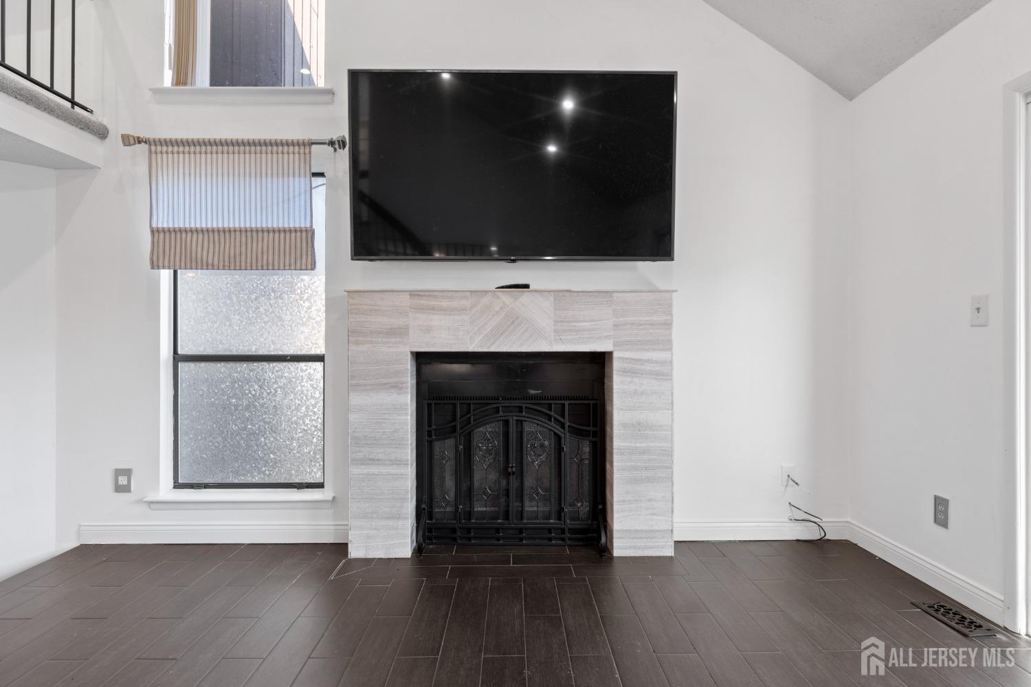 171 Westgate Drive Edison, NJ 08820 - Photo 10 of 49 a living room with a fireplace and a flat screen tv