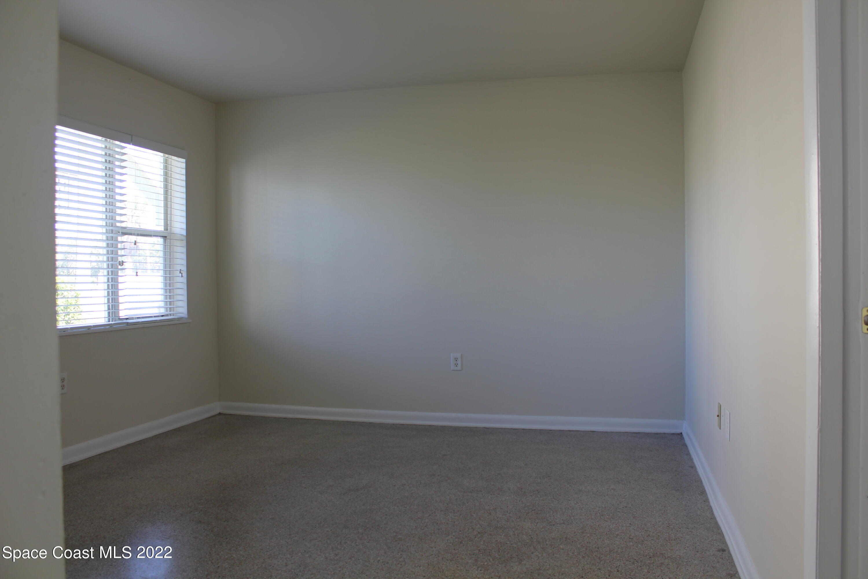 651 Palm Drive, Unit C2 Satellite Beach, FL 32937 - Photo 3 of 13 an empty room with a window