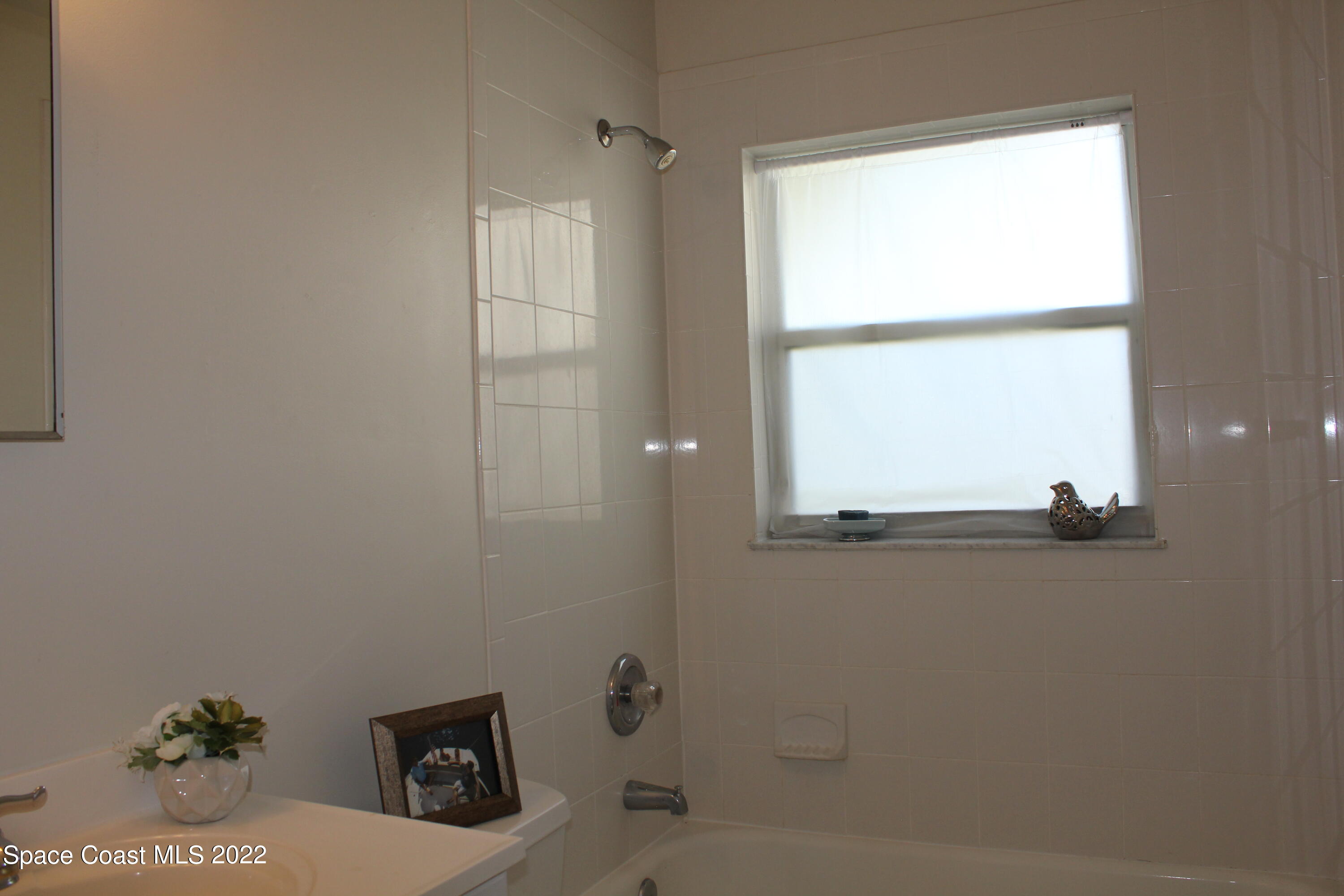 651 Palm Drive, Unit C2 Satellite Beach, FL 32937 - Photo 6 of 13 a bathroom with a sink and a window