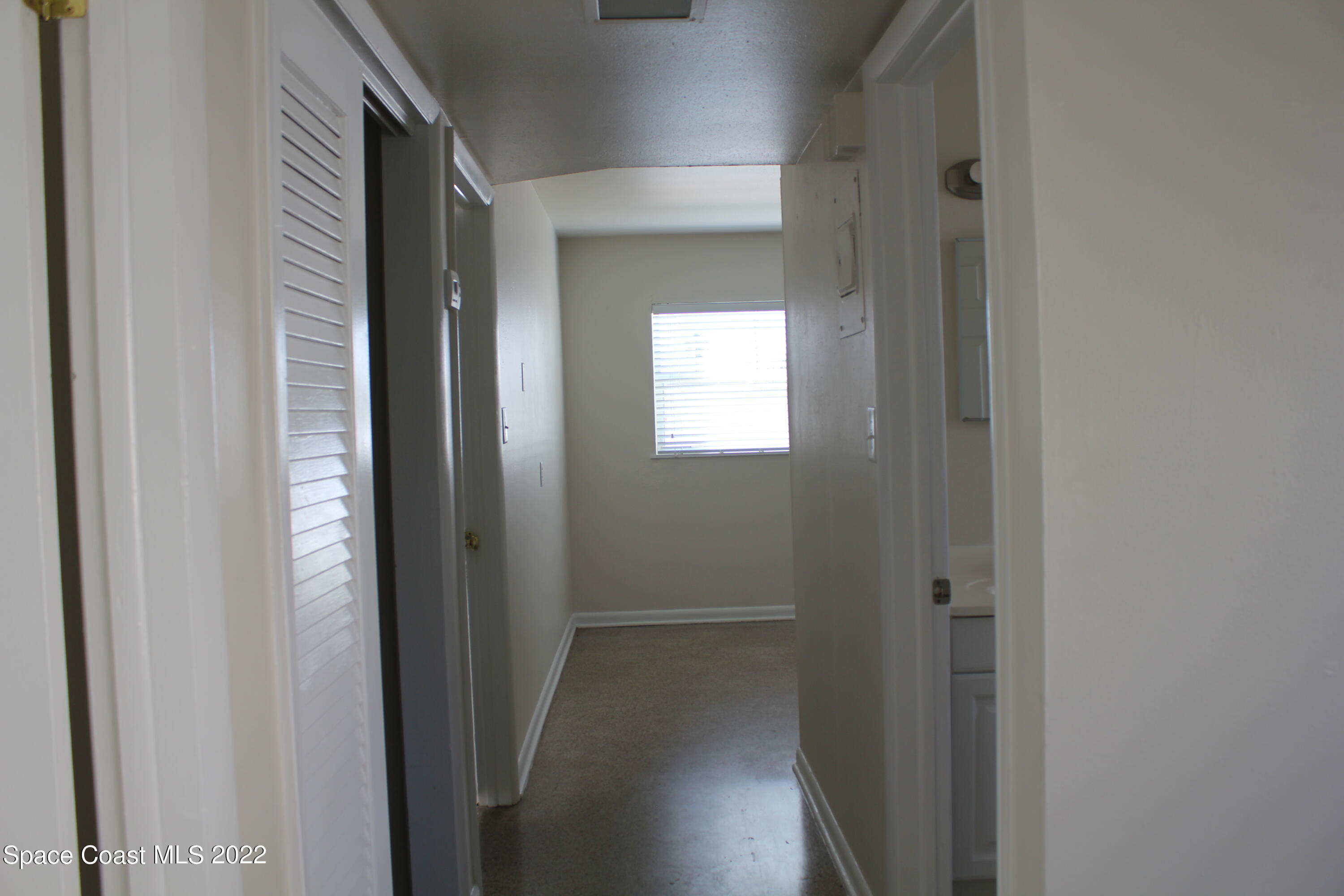 651 Palm Drive, Unit C2 Satellite Beach, FL 32937 - Photo 9 of 13 a view of a hallway with windows