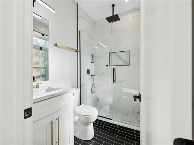 a bathroom with a sink toilet and shower