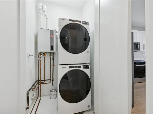 a view of a hallway with washer and dryer