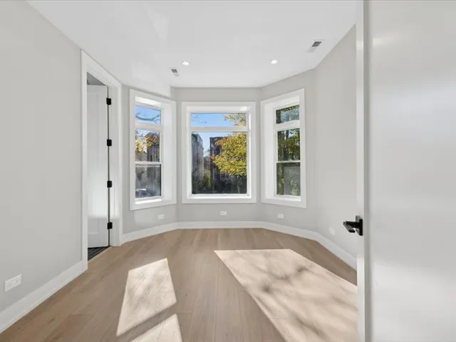 a spacious bathroom with a tub shower and windows