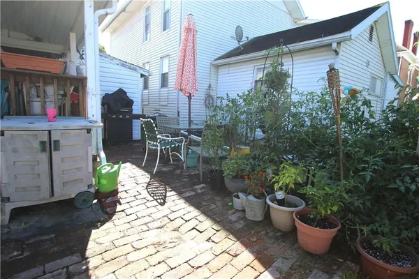 a front view of a house with sitting area