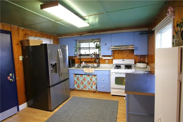 a kitchen with refrigerator and cabinets