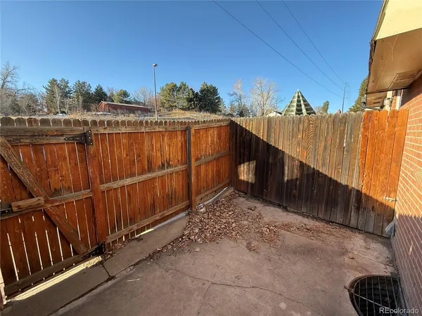 a view of a pathway with a wrought fence