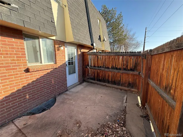 a view of a backyard with wooden fence