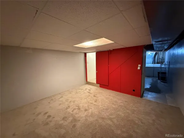 a view of a garage room with wooden floor and windows