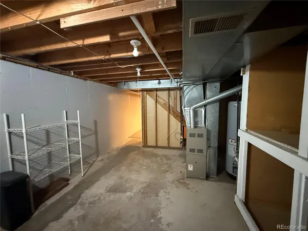 an empty room with a ceiling fan and a window