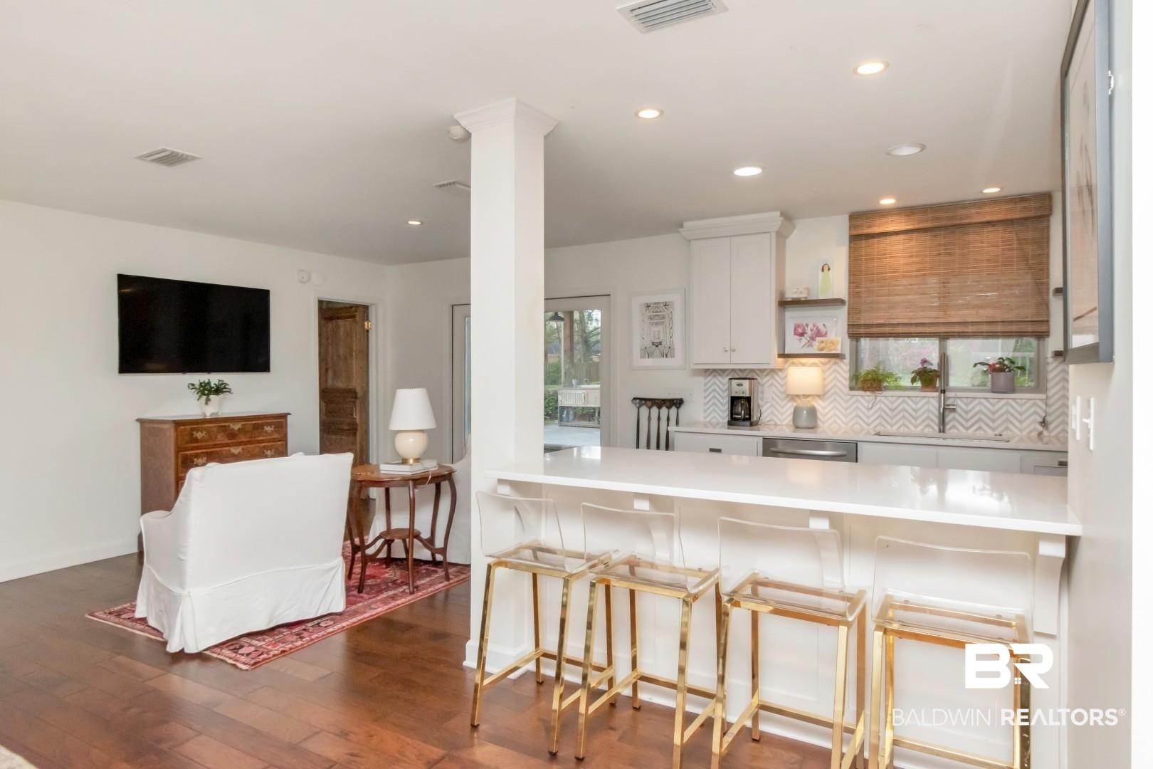 154 Fenwick Road Mobile, AL 36608 - Photo 12 of 48 Kitchen featuring a kitchen bar, a peninsula, tasteful backsplash, dark wood finished floors, and open shelves