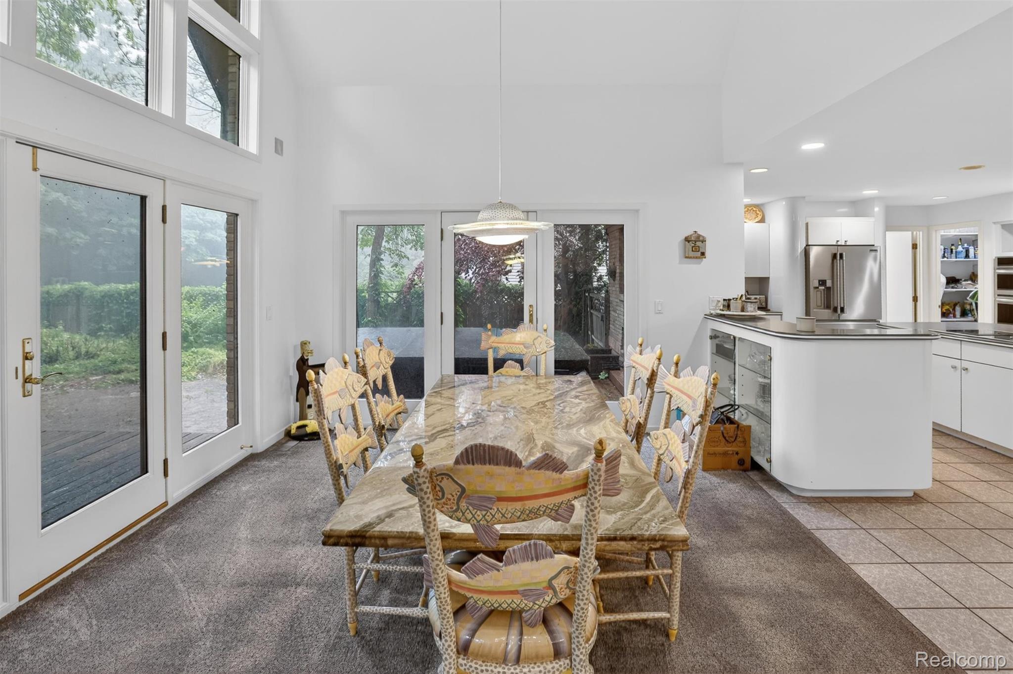 2197 South State Road Davison, MI 48423 - Photo 16 of 72 Spacious dining area featuring vaulted ceilings, a large window wall with transom windows, and multiple sets of glass-paneled French doors