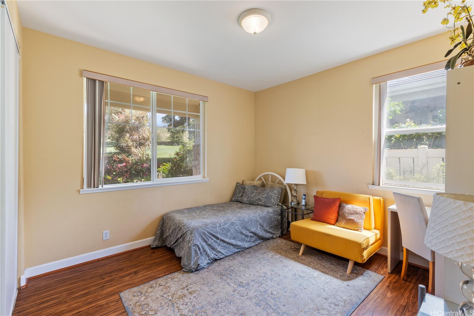 92-1015 Koio Drive, Unit S52 Kapolei, HI 96707 - Photo 12 of 18 a bedroom with a bed and wooden floor