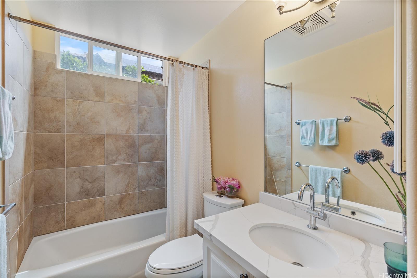 92-1015 Koio Drive, Unit S52 Kapolei, HI 96707 - Photo 13 of 18 a bathroom with a sink toilet and shower