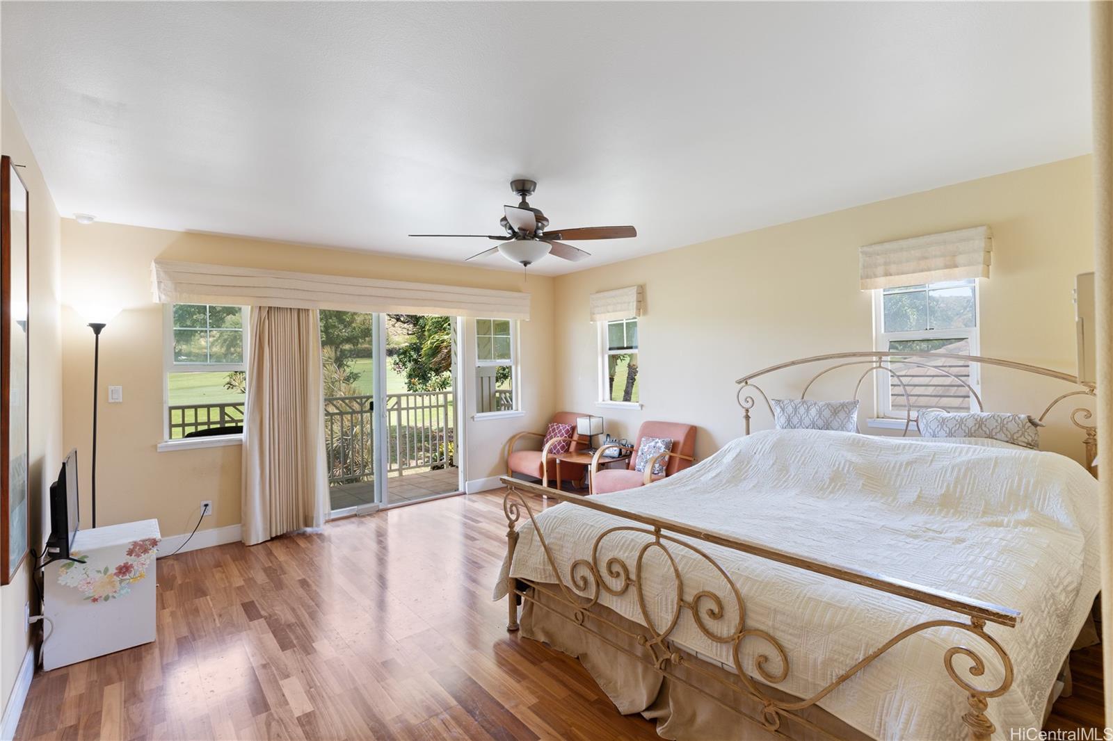 92-1015 Koio Drive, Unit S52 Kapolei, HI 96707 - Photo 18 of 18 a bedroom with a bed and wooden floor
