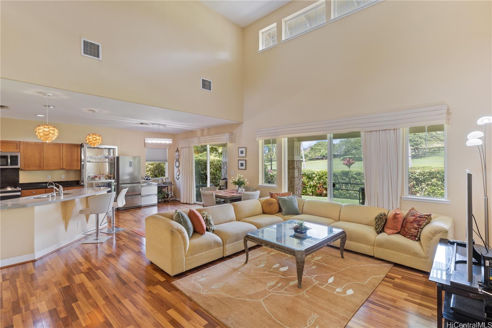92-1015 Koio Drive, Unit S52 Kapolei, HI 96707 - Photo 9 of 18 a living room with furniture wooden floor and a large window