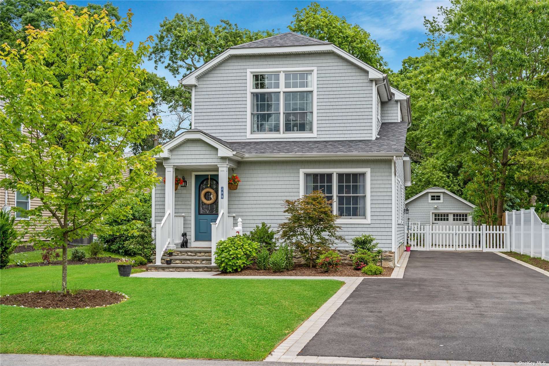 a front view of a house with a garden