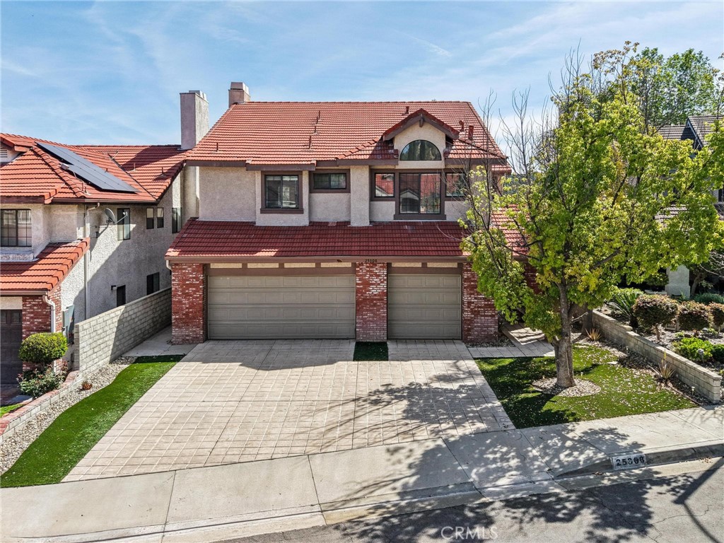 25308 Joyce Place Stevenson Ranch, CA 91381 - Photo 1 of 1 a front view of a house with a garden