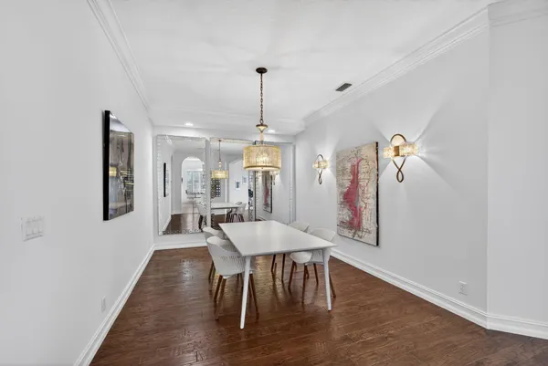 a view of a a dining room with furniture window and wooden floor