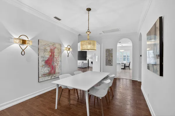 a view of a dining room with furniture wooden floor and chandelier