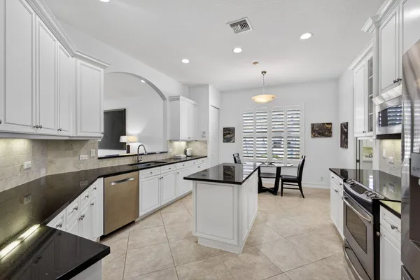 a large kitchen with lots of counter space and windows