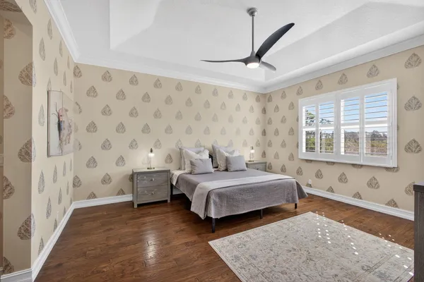 a spacious bedroom with a bed and a window in it