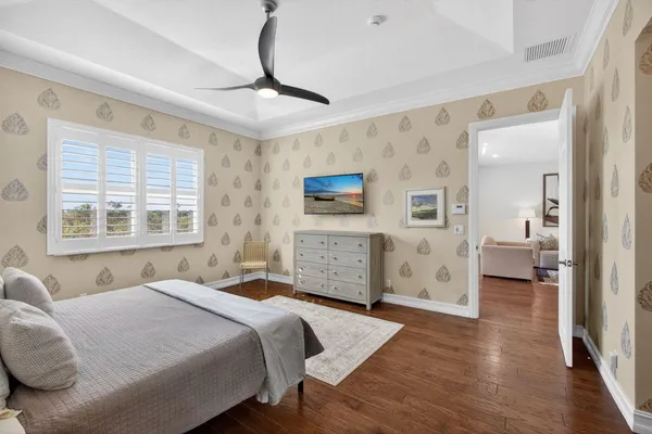 a spacious bedroom with a bed and a large window