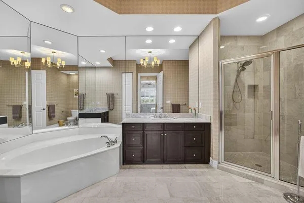 a bathroom with a sink tub shower and a mirror
