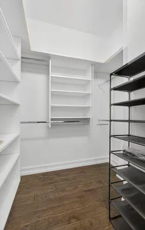 a view of walk in closet with empty racks