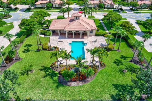 a view of a park with a big yard and potted plants
