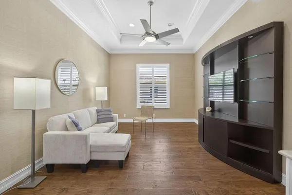 a living room with furniture a window and a chandelier