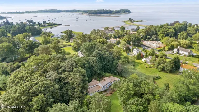 an aerial view of ocean with residential house and lake view