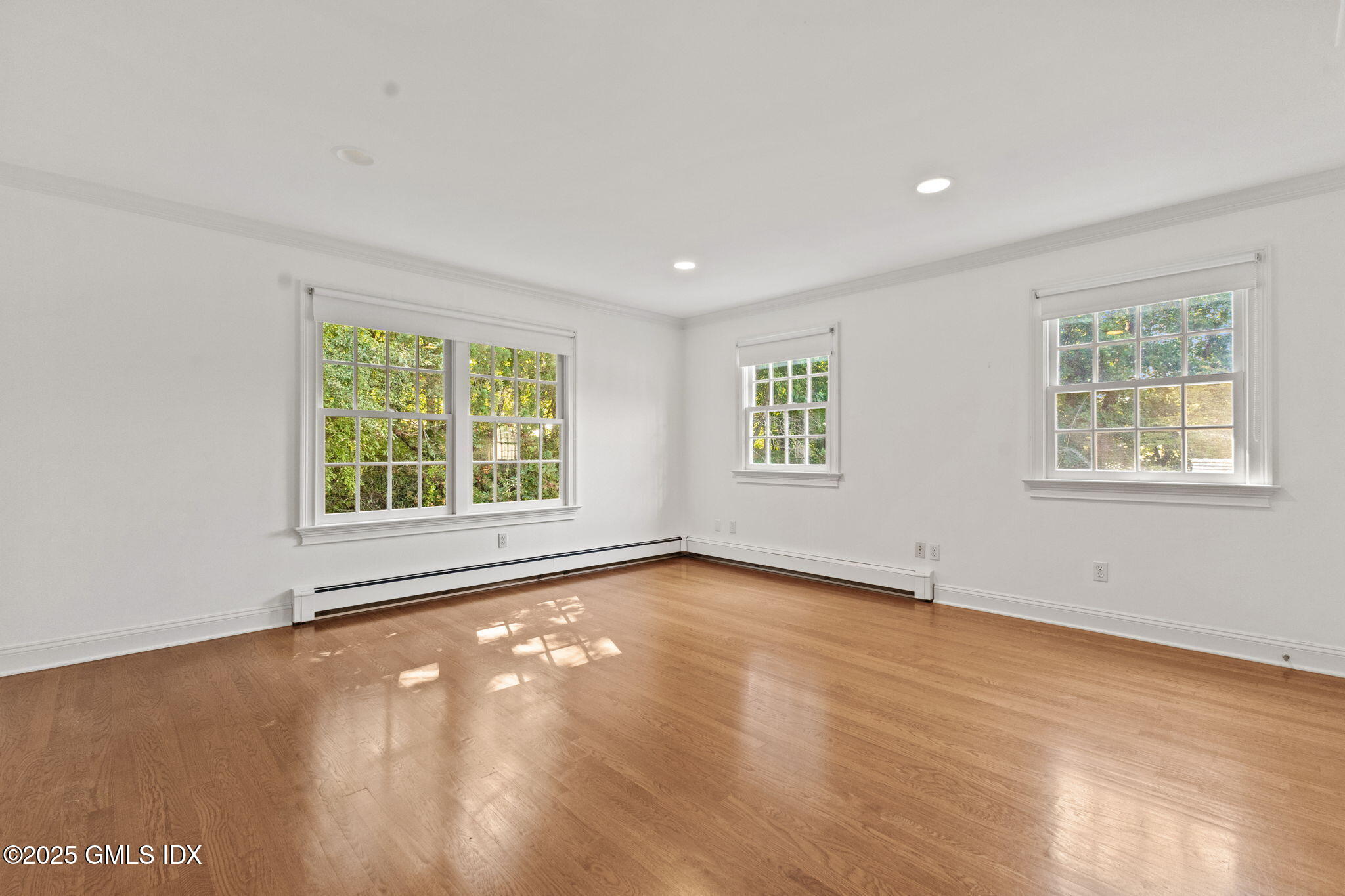 177 Indian Head Road Riverside, CT 06878 - Photo 16 of 25 an empty room with wooden floor and windows