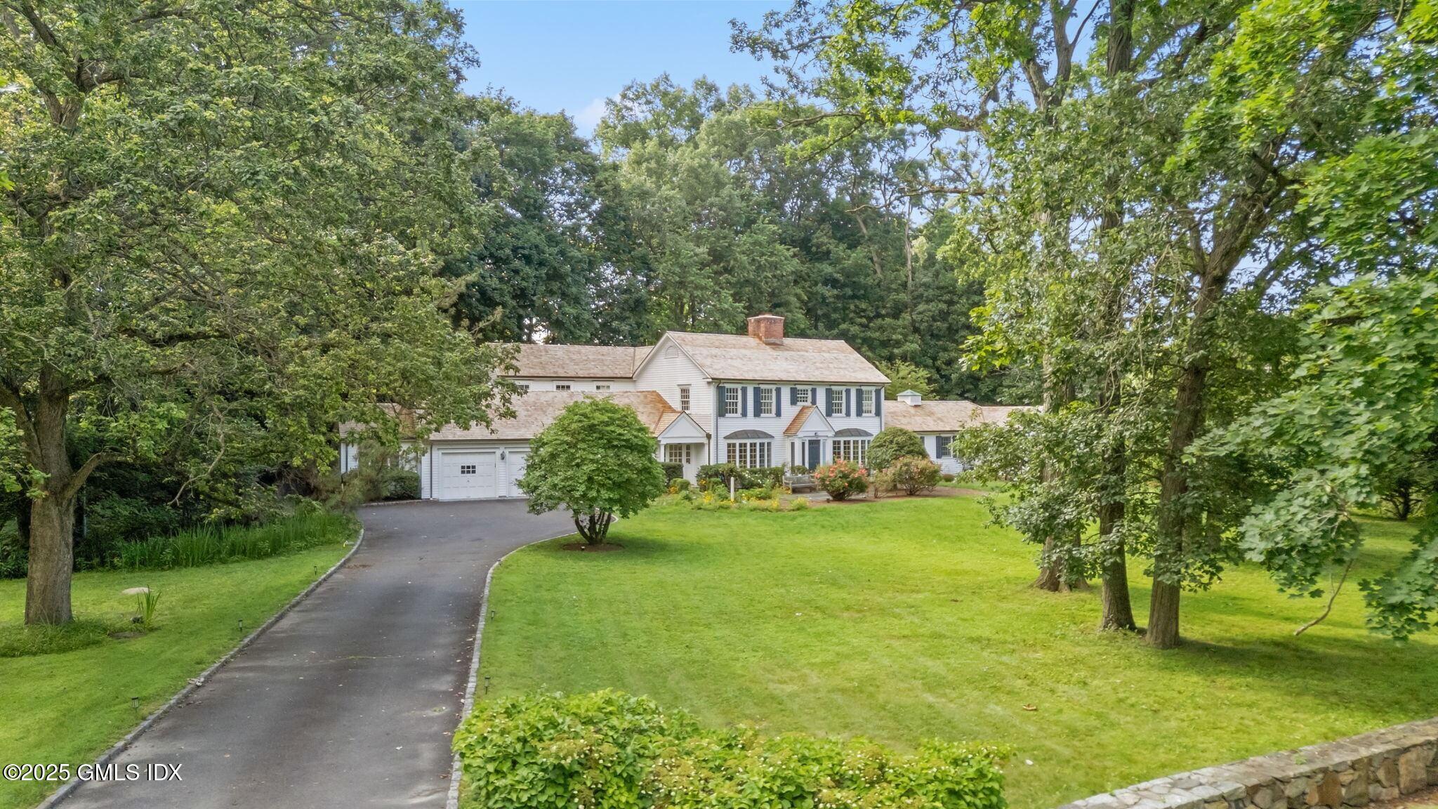 177 Indian Head Road Riverside, CT 06878 - Photo 2 of 25 a front view of a house with garden