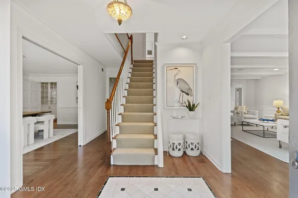 a view of an entryway with wooden floor and a rug