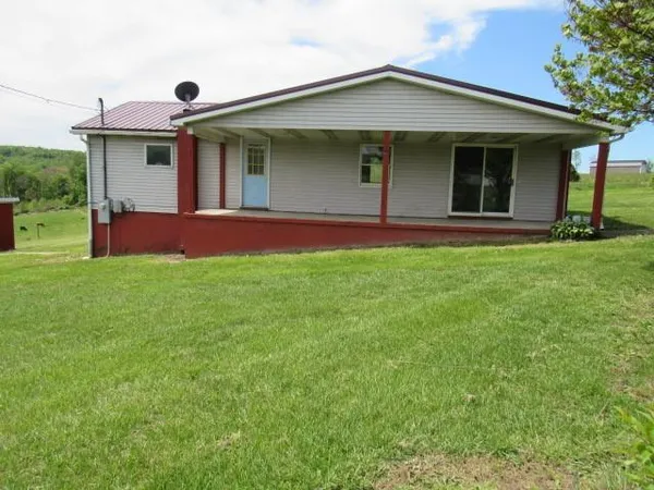 a view of a house with a yard and porch