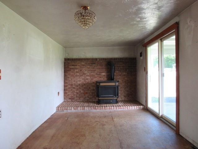 273 Odonnal Road Mill Run, PA 15464 - Photo 10 of 19 a view of an empty room with a fireplace and a window