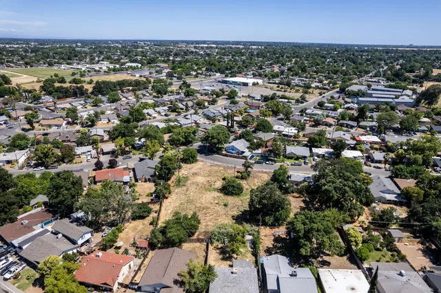 an aerial view of a city and mountain view in back