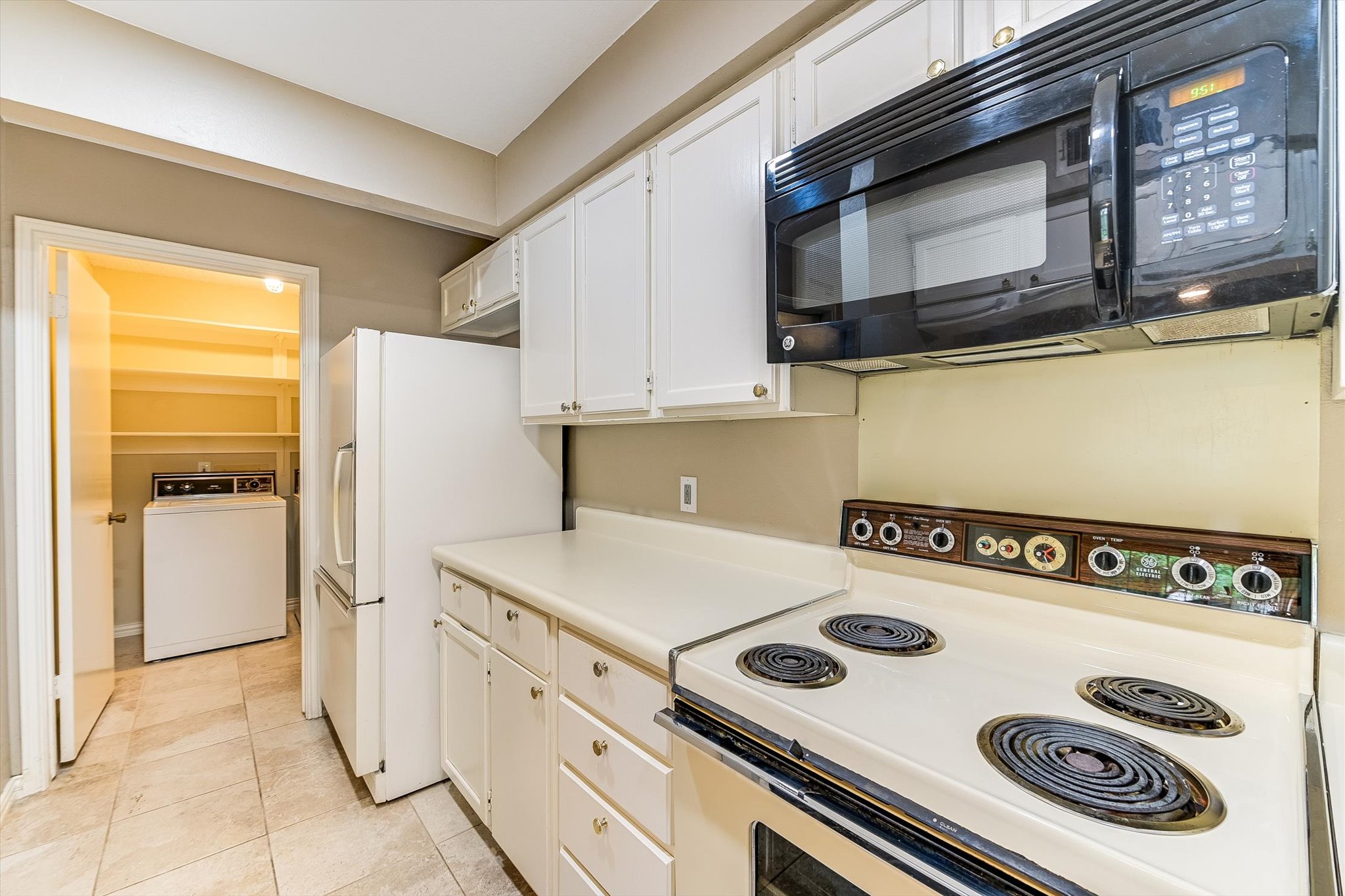 7919 Ridgeline North Austin, TX 78731 - Photo 12 of 23 a kitchen with a stove a refrigerator and a microwave